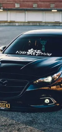 Upgrade your phone's background to this amazing live wallpaper! Displaying an impressive black sports car in a sleek parking lot, the design is topped off with intricate kanji tattoos and decals by the talented Shiba Kōkan
