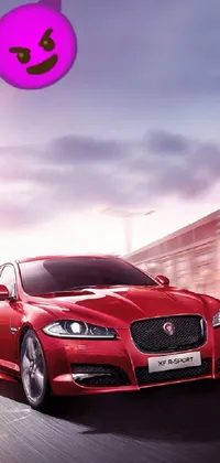 Looking for a vibrant live wallpaper to spruce up your mobile device? Check out this stunning design featuring a red jaguar sports car driving down a road next to a playful white cat