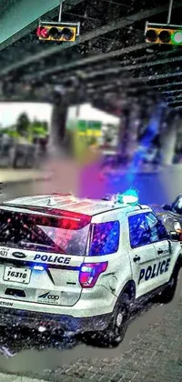 Experience the thrill of the chase with this action-packed live wallpaper for your phone! Chris Rallis' colorized photo features a police car speeding down a wet highway, hot on the trail of a criminal