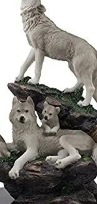 This live wallpaper showcases a group of wolf figurines perched atop a white, Amazonian-style statue