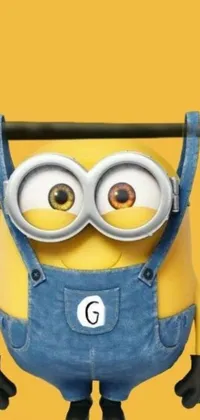 This phone live wallpaper features an adorable banana-colored minion character hanging from a pole, with large round expressive eyes