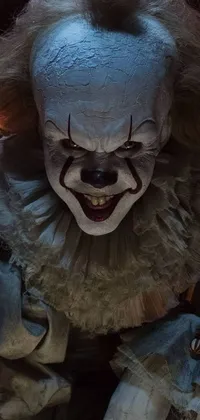 This is a live wallpaper featuring a creepy clown with a menacing smile, holding a knife