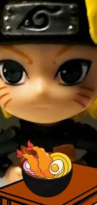 This phone live wallpaper features a close-up shot of a doll with a bowl of food placed on a table