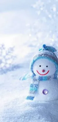 Add wintertime flair to your phone's home screen with a live wallpaper featuring a snowman in a red hat and warm scarf standing in the snow under a winter sky