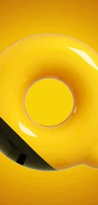 This live wallpaper is a playful and unique design featuring a yellow donut with a knife sticking out of it