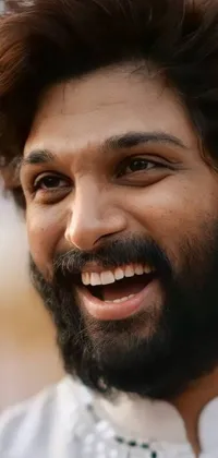 This live phone wallpaper portrays a close-up of a bearded person with an infectious smile and attractive dimples