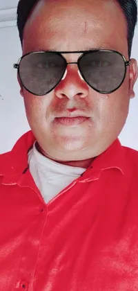 This phone live wallpaper features a stylish man sporting sunglasses and a vibrant red shirt