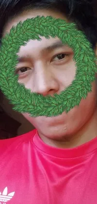 This live wallpaper for your phone features a vibrant and captivating image of a man with a wreath painted on his face