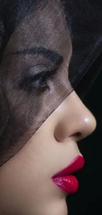 This phone live wallpaper features a close-up of a veiled woman with stunning, sexy lips