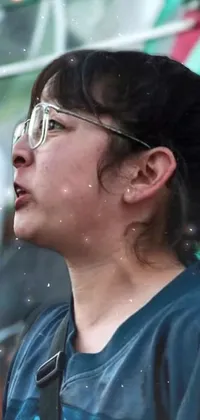 Get an eye-catching phone live wallpaper featuring a determined woman wearing glasses