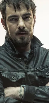 This edgy phone live wallpaper features a striking portrait of a confidently posed man in a leather jacket