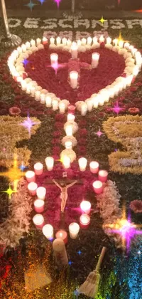 This phone live wallpaper showcases a gorgeous heart-shaped arrangement of candles that form an intricate mosaic
