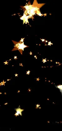 This stunning Christmas phone live wallpaper features a beautiful digital art design of a Christmas tree made out of twinkling stars set against a black background