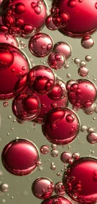 This phone live wallpaper boasts an eye-catching digital art design of red bubbles floating in water