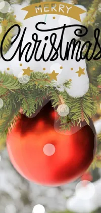 This phone live wallpaper displays a beautiful red ornament hung from a Christmas tree, reminiscent of a snowglobe