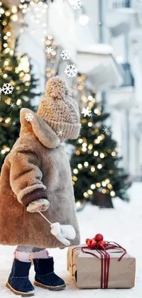 This charming live wallpaper depicts a young girl in a light brown coat giving gifts to people against a snowy background