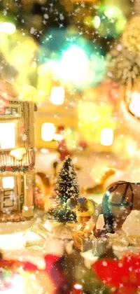 This Christmas themed live wallpaper features a picturesque village tucked away in the snow