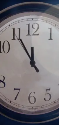 This live wallpaper showcases a close-up of a clock with a black and white design set against a textured background