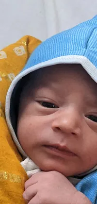 This phone live wallpaper offers a touching close-up of a peaceful, sleeping baby wrapped in a blanket