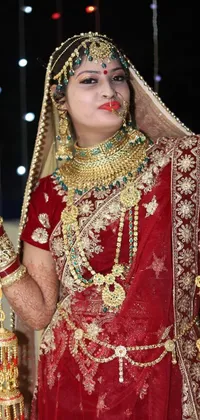 This phone live wallpaper showcases a stunning Indian bride in a red and gold outfit with intricate henna designs on her hands