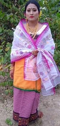 This live phone wallpaper showcases a woman in a vibrant outfit with a pink and white cloth and a colorful shawl draped over her shoulders