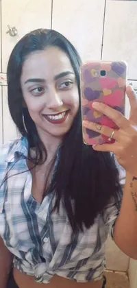 Looking for a playful and artistic wallpaper for your phone? Look no further than this live wallpaper featuring a gorgeous Latina taking a selfie in a steamy bathroom mirror