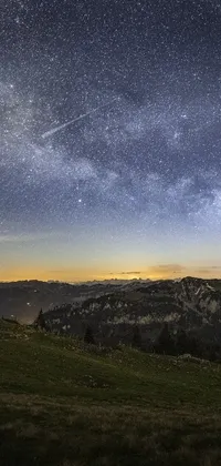 This stunning live wallpaper features a breathtaking view of the night sky from a hilltop in the Swiss Alps