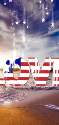 This phone live wallpaper features the word "love" in the colors of the American flag set against a stunning oceanside backdrop