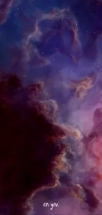 This phone live wallpaper showcases beautiful clouds in the sky colored red and purple, resembling space art