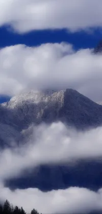 This phone live wallpaper depicts a plane flying over a stunning mountain range covered in fluffy clouds and snow
