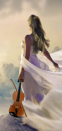 This phone live wallpaper features a stunning scene of a woman standing on a mountain with a violin, surrounded by nature