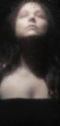 This captivating live wallpaper features a stunning black and white image of a woman with her eyes shut in a meditative state, showcasing a symmetrically composed portrait