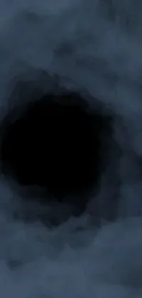 This stunning phone live wallpaper offers a captivating black hole situated in the middle of a beautiful and snowy landscape