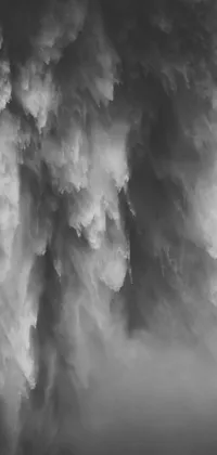 This live phone wallpaper showcases a black and white photograph of a cloudy sky, transformed into lyrical abstraction, and set inside a Washington waterfall