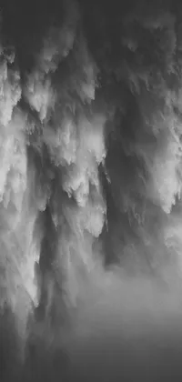 This live phone wallpaper showcases a captivating monochrome photograph of a cloudy sky and tumbling waterfalls, captured with remarkable detail and depth