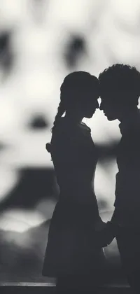 This phone wallpaper depicts a charming black and white photo of a couple standing together in front of a window