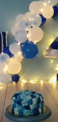 This phone live wallpaper features a blue and white cake on a table, trending on Instagram for its beauty