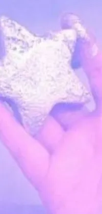 This live wallpaper shows a person holding a star-shaped object emitting a soft glow