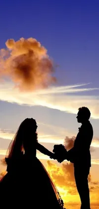 This stunning phone live wallpaper features a beautiful silhouette of a bride and groom holding hands against the sky