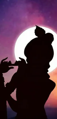 This phone live wallpaper depicts a stunning silhouette of someone playing the flute in front of a breathtaking moonlit sky