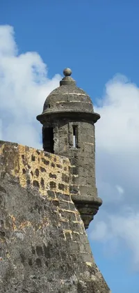 This live wallpaper depicts a baroque tower resting atop a stone wall