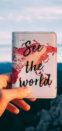 This live wallpaper features a hand holding a wallet with the phrase "see the world" printed on it