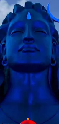 This is a stunning live wallpaper for phones, featuring a close-up of an intricate statue emitting a beautiful blue light in a dark blue sky
