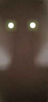 This phone live wallpaper features a striking close-up of an ominous figure with eerie glowing eyes