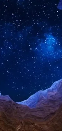 This phone live wallpaper is a stunning depiction of the night sky seen from a cave, set amidst towering mountains