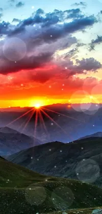 This stunning live wallpaper portrays a breathtaking sunset over a mountain range, creating a romantic and serene atmosphere
