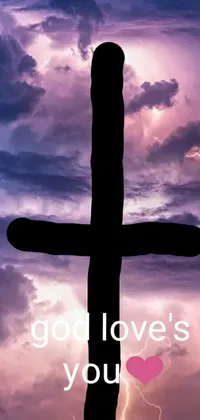This phone live wallpaper depicts a cross with "God loves you" message, enveloped by lightning in an oversaturated, intense milieu