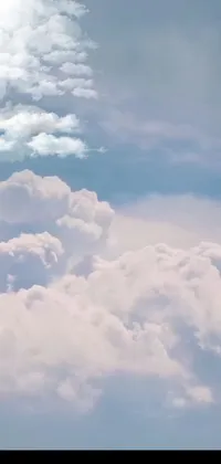 Transform your phone's home screen with a stunning live wallpaper! This high-resolution image depicts a massive jetliner soaring through a breathtaking sky filled with fluffy cumulus clouds