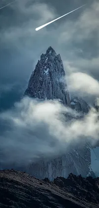 This live wallpaper features a portrait orientation of a snow-covered mountain under a cloudy sky
