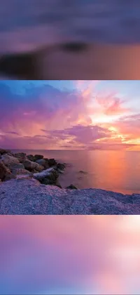 This stunning live wallpaper showcases a peaceful beach scene with two rocks against a colorful sunset background